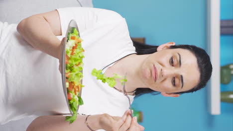 Vertical-video-of-The-dieter-gets-tired-of-eating-salad.-A-person-struggling-with-a-diet.